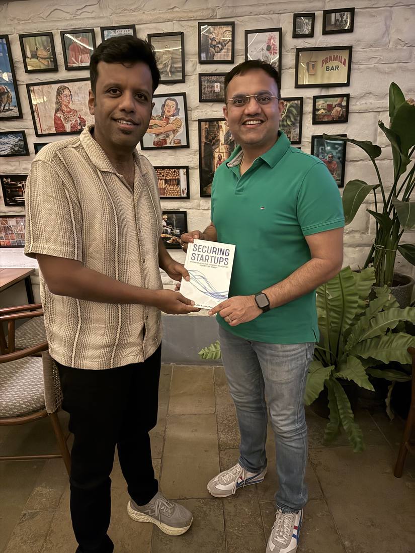 Sanil Nadkarni handing over a copy of Securing Startups